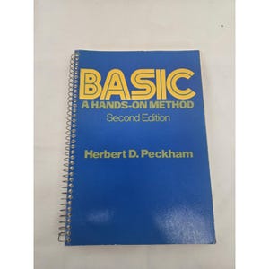 May include: A spiral-bound textbook with a blue cover featuring yellow text that reads BASIC A HANDS-ON METHOD Second Edition by Herbert D. Peckham. The book has a metal coil spine on the left side and a clean, rectangular design throughout.