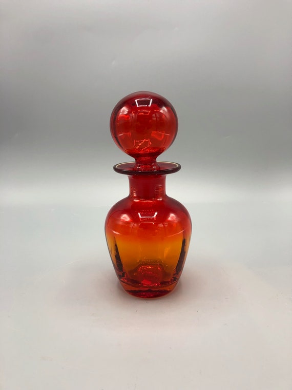 Blenko Glass Co.:  1.  Red optic decanter  with flared rim and red ball stopper, No.  715, unmarked; 7 1/2”H