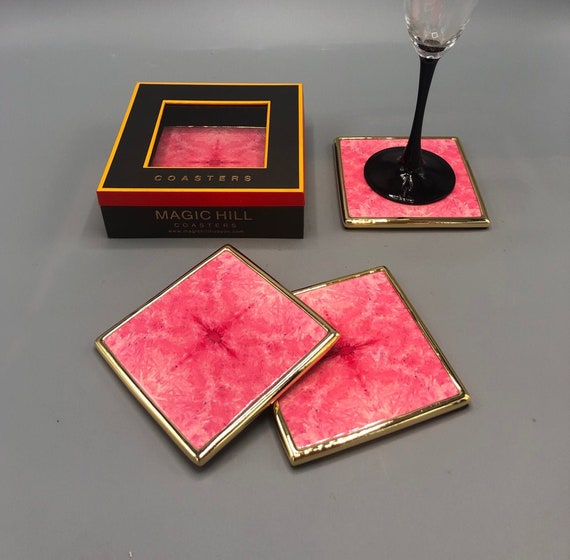 Handmade ceramic coasters with brass trim and velvet bottom. Art by Bruce Mishell