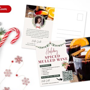 May include: A postcard with a festive holiday theme featuring a recipe for spiced mulled wine. The postcard has a red and green color scheme with a festive wreath and a QR code to scan for the full recipe. The text on the postcard reads "Holiday Spiced Mulled Wine" and includes a list of ingredients.