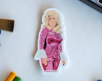 May include: A sticker featuring a pink and white illustration of a woman with blonde hair. The woman is wearing a pink jacket with a white collar and white cuffs. The sticker has the text "@mgsprintshop" at the bottom.