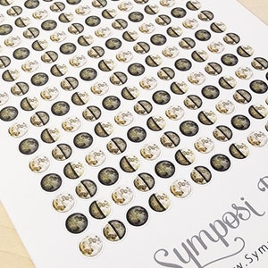 May include: A sheet of moon phase stickers with a white background. The stickers are round and feature a variety of moon phases, including a full moon, a crescent moon, and a new moon. The stickers are perfect for adding a touch of whimsy to planners, journals, and other paper goods.