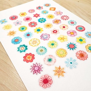 May include: A sheet of colorful flower stickers with a variety of designs and colors. The stickers are arranged in rows and columns on a white background.