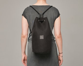 Black backpack made from strong polyester, waterproof bag for woman and for men, casual style, sportbag, round shape