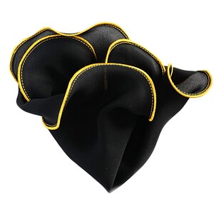 May include: A black pocket square with a yellow stitched border. The pocket square is folded and has a ruffled edge.