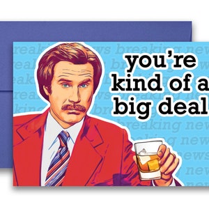 May include: A greeting card featuring a cartoon illustration of a man in a red suit holding a glass of whiskey. The text on the card reads "you're kind of a big deal".