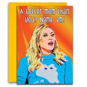 May include: A greeting card with a cartoon image of a woman with blonde hair and a blue sweater with a white cat on it. The text on the card reads "A better mom than you? Name 'em!"