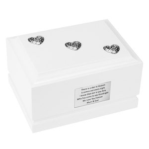 May include: A white wooden box with three silver heart decorations on the lid. A silver plaque on the front of the box has engraved text. The box is a memorial keepsake.