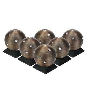 May include: Set of six decorative spheres with a rustic brown finish and white star cutouts. Each sphere sits on a black square base.