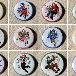 May include: A collection of twelve round pinback buttons featuring colorful anime-style illustrations of characters. Each button has a white background with a character illustration and a name. The buttons have different colored borders, including yellow, blue, red, green, and purple.