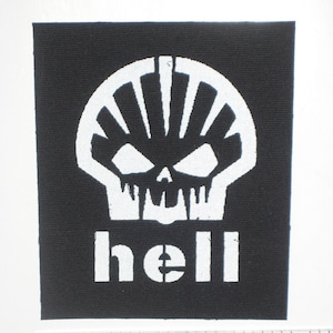 May include: Black and white patch with a skull design and the word "hell" printed below. The skull has a white shell-like shape on the top of the head.