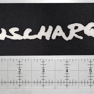 May include: White text on a black background reads "DISCHARGE".