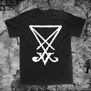 May include: Black t-shirt with a white inverted pentagram symbol.