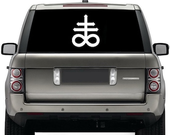 May include: A white symbol of a cross with an infinity symbol at the bottom, on a black background. The symbol is on the back window of a silver SUV.