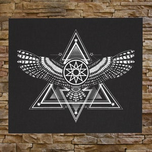 May include: Black canvas art print featuring a detailed white illustration of an owl with outstretched wings. The design incorporates geometric shapes, including triangles, stars, and a central circular emblem. The artwork has a symmetrical composition.