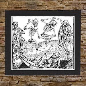 May include: Black and white woodcut print depicting four skeletons dancing. The skeletons are dressed in robes and are holding hands. The print is framed in a black frame.
