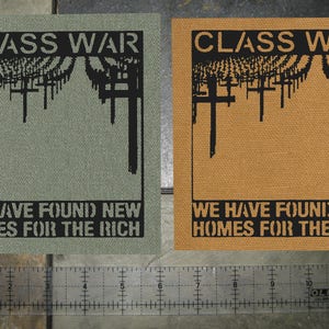 May include: Two fabric patches with the text "CLASS WAR" and "WE HAVE FOUND NEW HOMES FOR THE RICH" in black lettering on a green and brown background.