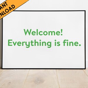 May include: A black framed poster with white background and green text that reads "Welcome! Everything is fine."