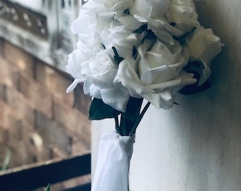 Winter white, open blooms and reflexed winter white rose bouquet and groom buttonhole