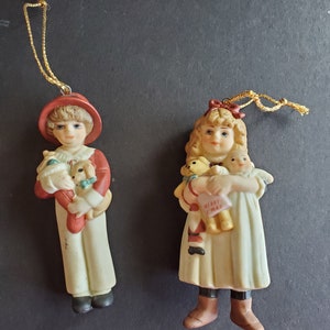 Vintage 1984 Jan Hagara “Chris” and “Carol” Mini Bisque Hanging Ornaments