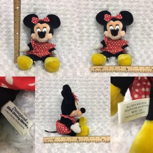 May include: A red and white polka dot dress with a red bow on top of the head. The plush toy is a Mickey Mouse character. The tag reads "Disneyland Walt Disney World Walt Disney Productions" and "All New Material Polyester Stuffing MFR-102 Product of Korea".