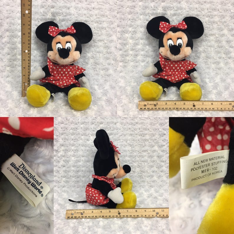 May include: A red and white polka dot dress with a red bow on top of the head. The plush toy is a Mickey Mouse character. The tag reads "Disneyland Walt Disney World Walt Disney Productions" and "All New Material Polyester Stuffing MFR-102 Product of Korea".