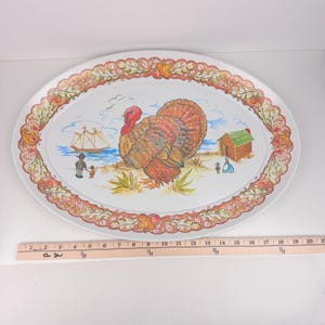 Puede incluir: Bandeja ovalada para servir con temática de Acción de Gracias. La bandeja presenta un gran pavo, un velero y una pequeña cabaña en una playa. El borde tiene un patrón decorativo con calabazas y hojas. La bandeja mide unos 51 cm de largo.
