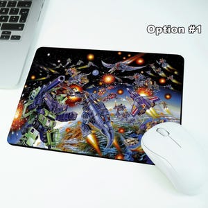 May include: A rectangular mousepad featuring a colorful illustration of a battle scene with robots and spaceships. The mousepad is next to a white wireless mouse, a laptop, and wireless earbuds. The text "Option #1" is in the upper right corner.