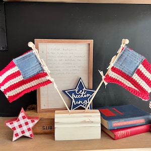 Americana flag with crocheted stripes and quilted chambray square on wooden trim base
