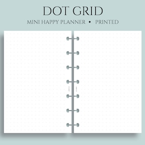 May include: A white, dot grid notebook with a black spine and silver rings. The notebook is open to reveal the blank pages. The text "DOT GRID" is printed in black at the top of the page, and the text "MINI HAPPY PLANNER PRINTED" is printed in black below it.