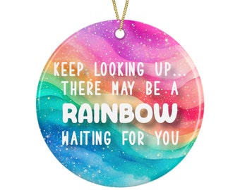 May include: A round ceramic bauble with a rainbow watercolour background and the text "Keep looking up... there may be a rainbow waiting for you."