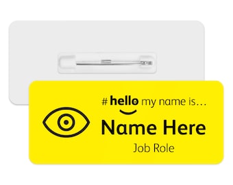 May include: Yellow name tag with a black eye icon and the text "#hello my name is... Name Here Job Role"
