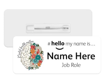 May include: White name tag with a pin. The tag features a colorful floral design with a brain in the center. The text "Mental health matters" is written around the brain. The text "#hello my name is... Name Here Job Role" is printed on the tag.