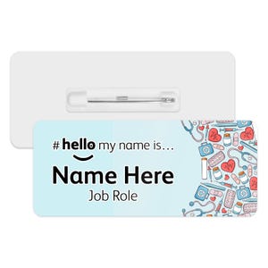 May include: A light blue name tag with a white pin. The tag has a medical theme with a stethoscope, pills, and hearts. The text on the tag reads "#hello my name is... Name Here Job Role".