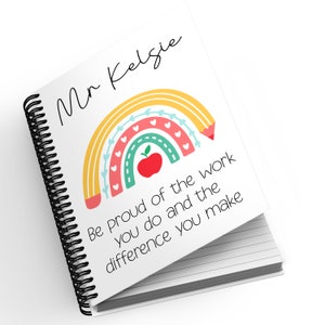 May include: A white spiral notebook with a rainbow and apple design. The cover reads "Mr Kelsie" and "Be Proud of the work you do and the difference you make".
