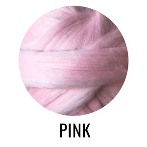 May include: Close-up of a pink wool yarn, showing the soft texture and fluffy fibers. The yarn is tightly wound into a circle.