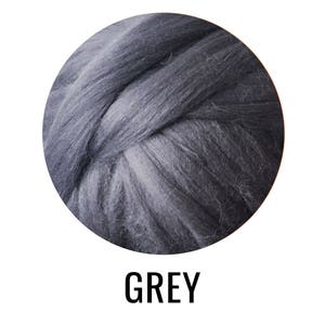 May include: A close-up of a ball of grey wool yarn. The yarn is soft and fluffy, and it is perfect for knitting or crocheting.