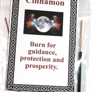 May include: A package of black incense sticks with a white label that says "Cinnamon". The label also has a picture of a full moon and the text "Burn for guidance, protection and prosperity."