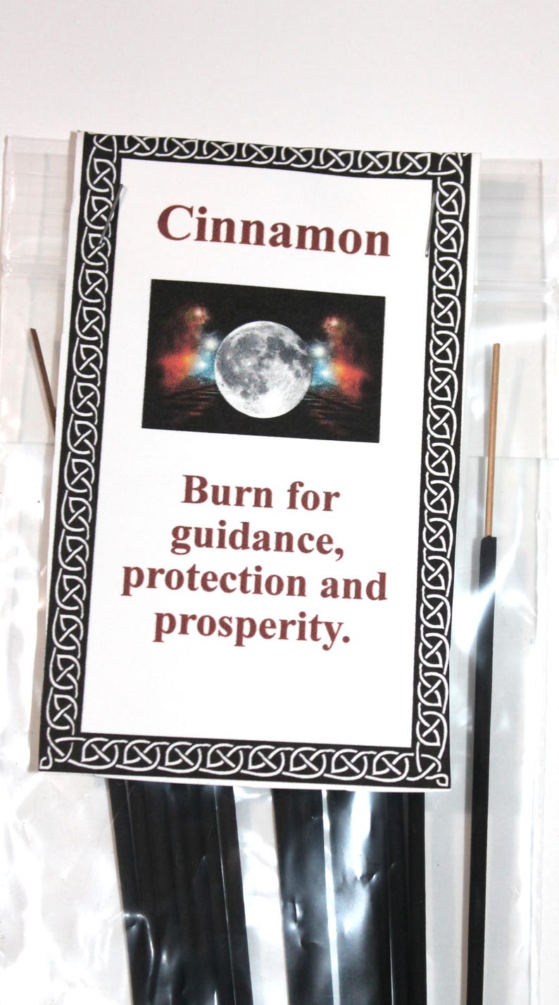 May include: A package of black incense sticks with a white label that says "Cinnamon". The label also has a picture of a full moon and the text "Burn for guidance, protection and prosperity."