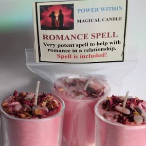 May include: Three pink candles in clear glass holders, topped with dried flowers and crystals. A label reads "ROMANCE SPELL" and "MAGICAL CANDLE". The candles are designed to help with romance in a relationship.