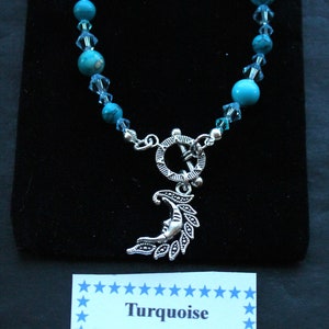 May include: Turquoise gemstone bracelet with a silver crescent moon charm. The card reads "Turquoise Excellent for calming anxiety and brings the wearer strength and leadership."