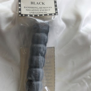 May include: A black wishing candle in a clear plastic bag. The label reads "Wishing Candle - Black" and "Banishing, removes negative energy and sadness."