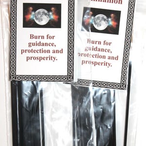 May include: Two packages of black incense sticks with a white label that reads "Cinnamon" and "Burn for guidance, protection and prosperity."
