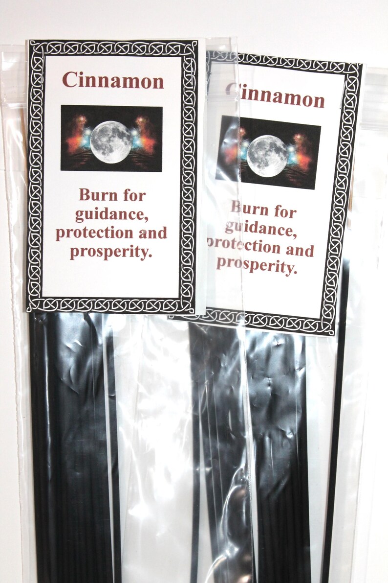 May include: Two packages of black incense sticks with a white label that reads "Cinnamon" and "Burn for guidance, protection and prosperity."