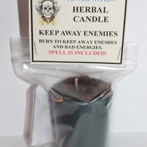 May include: A dark teal herbal candle in a clear plastic bag. The candle has a white wick and is topped with dark red pieces. A white label with black text reads "POWER WITHIN HERBAL CANDLE KEEP AWAY ENEMIES".