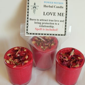 May include: Three red glass candle jars with a white wick and dried rose petals and herbs on top. The label reads "POWER WITHIN Herbal Candle LOVE ME Burn to attract true love and bring protection to a relationship. Spell is included!"
