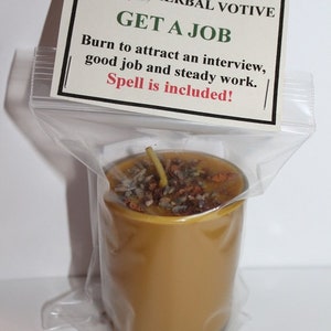 May include: A small, clear glass jar filled with a golden yellow candle. The candle is topped with dried herbs and spices. The jar is labeled "POWER WITHIN HERBAL VOTIVE GET A JOB Burn to attract an interview, good job and steady work. Spell is included!"