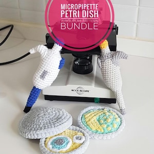 May include: Two crocheted amigurumi micropipettes and two crocheted petri dishes with yellow and blue details. A pink circular overlay features the text MICROPIPETTE PETRI DISH AMIGURUMI PATTERN BUNDLE and the bottom text reads US ENGLISH PDF.