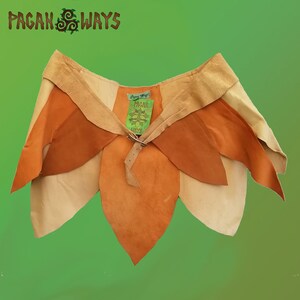 May include: A brown leather skirt with a flower petal design. The skirt has a brown leather belt with a buckle and a tag that says "Pagan Ways".