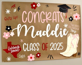 May include: A brown graduation banner with the words "Congrats Maddie Class of 2025" in pink and white. The banner includes a graduation cap, cowboy boots, and floral accents. The words "These boots are made for Texas" are also included.